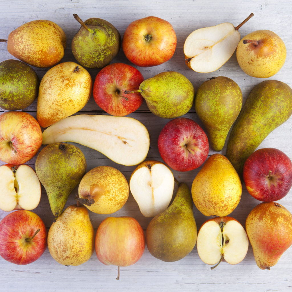 Apples And Pears Whole And Halved Shot From Above On White Wooden Boards