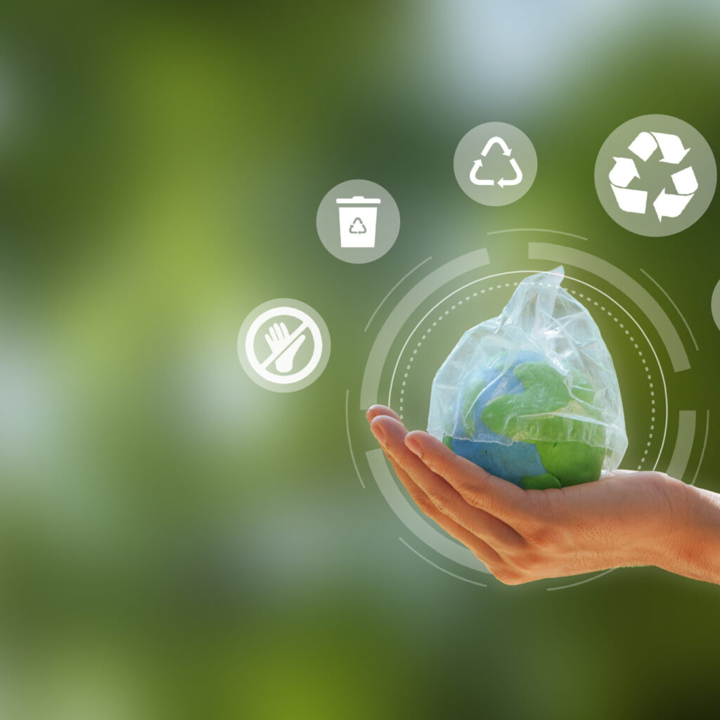 Zero Waste. Hand Holding The Earth That Plastic Bag Covering On A Green Background. Concept Of Reuse Reduce Recycle Rot Refuse. Zero Waste. Conscious Consumption. Save Water, World Water Day.